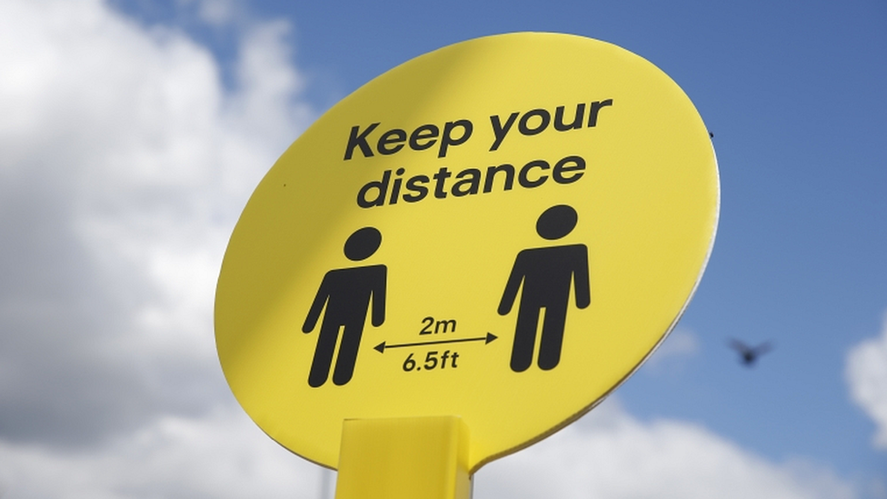 sign urging people to social distance