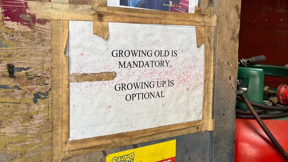 A sign that reads, 'Growing old is mandatory. Growing up is optional'