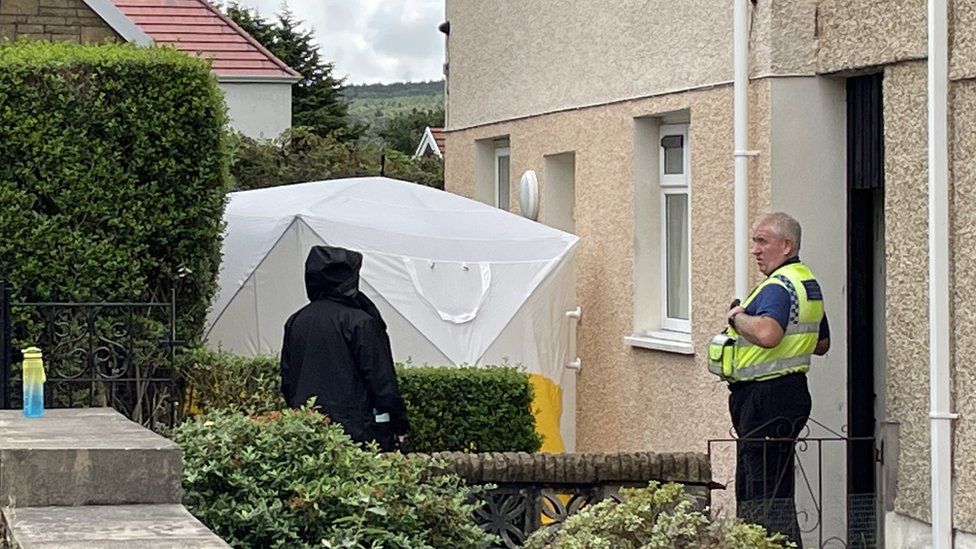 The 71-year-old was found dead at a property in Swansea
