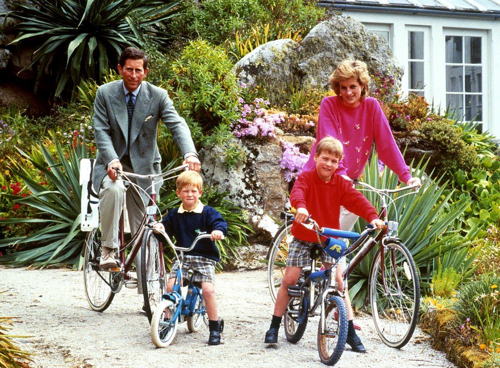 The Prince and Princess of Wales with Harry and William on bikes