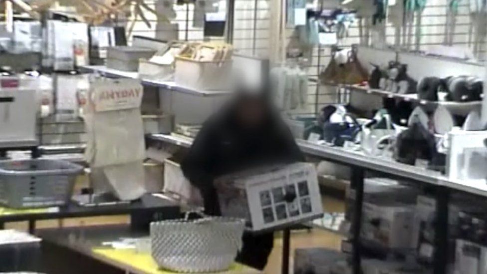 CCTV captured a man walking out of the shop with a large electrical item