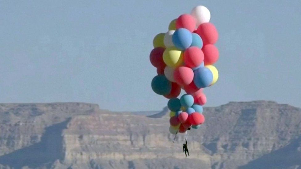 David Blaine holds on to balloons