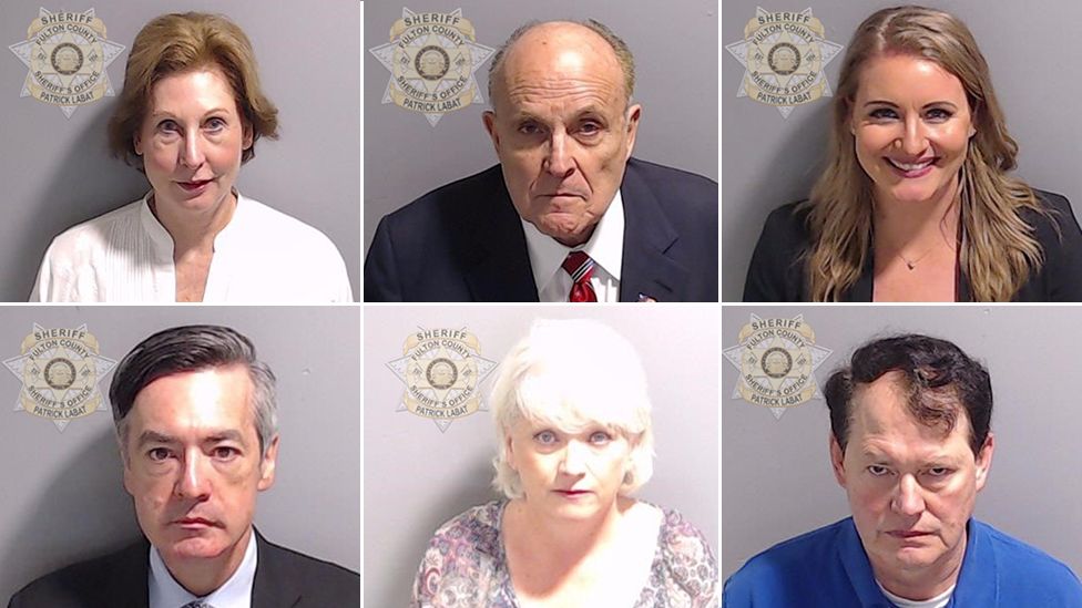 A composite of mugshots showing Sidney Powell, Rudy Giuliani, Jenna Ellis, Kenneth Chesebro, Cathy Latham and Ray Smith