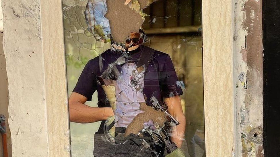 A smashed portrait of a Palestinian militant in Jenin refugee camp, in the occupied West Bank, following a major Israeli military operation (5 July 2023)