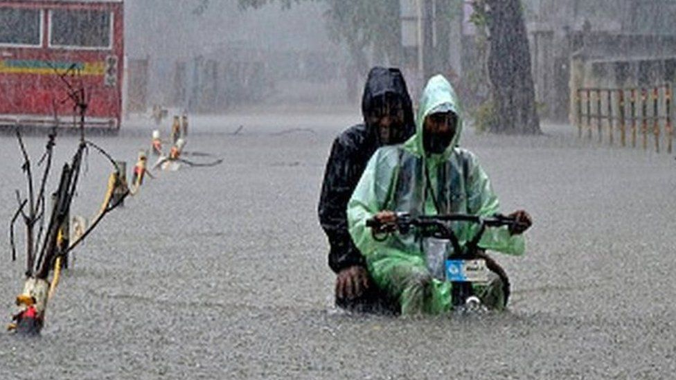 A delivery boy with an electric cycle wades through a flooded street due to heavy rainfall in Mumbai, India, 05 July, 2022.