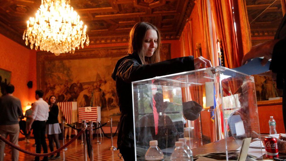 A woman votes at the French consulate in New York