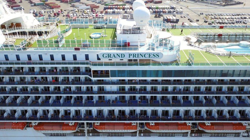 Passengers look out as the Grand Princess cruise ship docks at the Port of Oakland in Oakland, California on 9 March, 2020