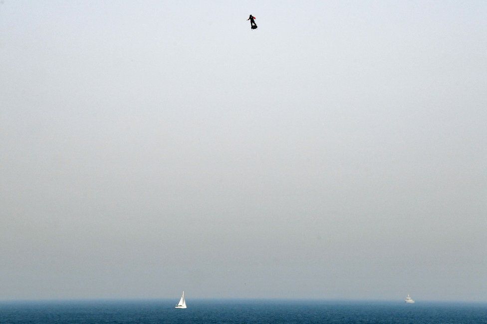 Franky Zapata stands on his jet-powered flyboard as he takes off from Sangatte, northern France