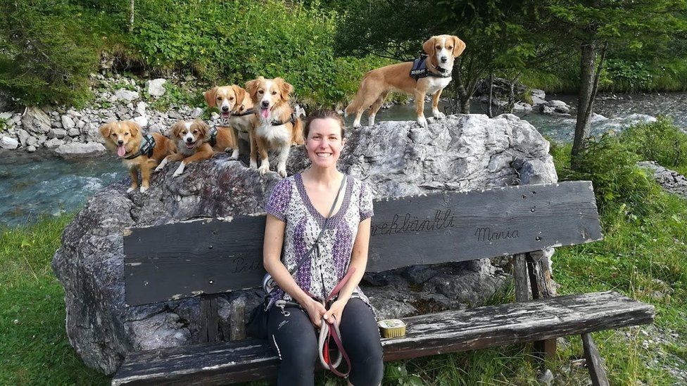 Esther with five dogs