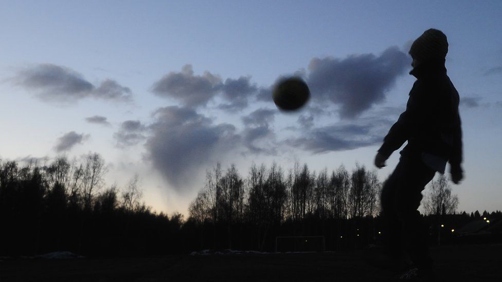 A child plays football in a park in Vaasa, Finland, 16 April 16 2010