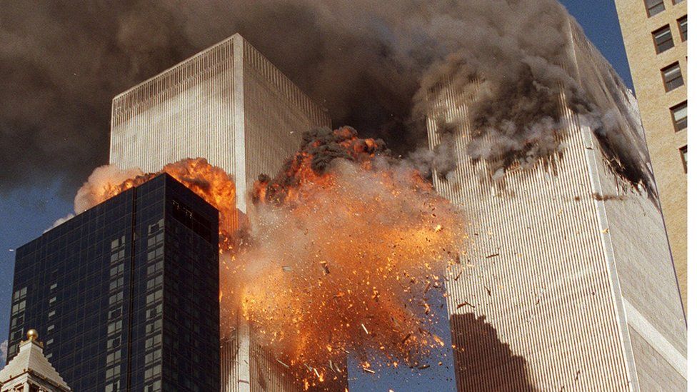 In this Sept. 11, 2001, file photo, smoke billows from one of the towers of the World Trade Center and flames as debris explodes from the second tower in New York.