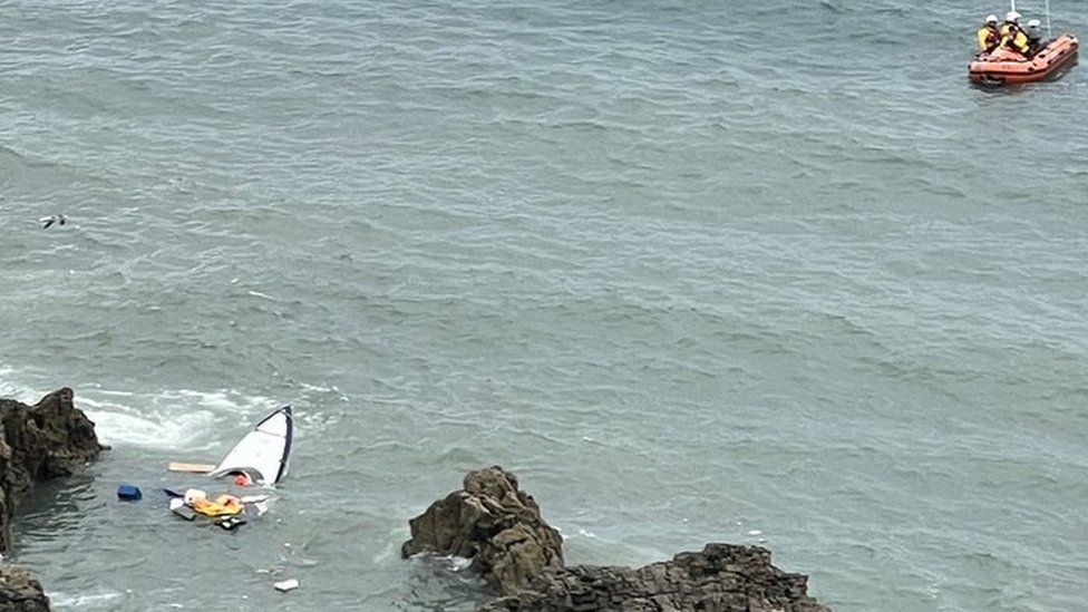 part of sunken boat in sea