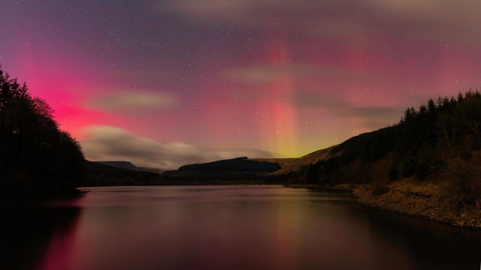Northern lights reflecting onto water in Caerphilly county