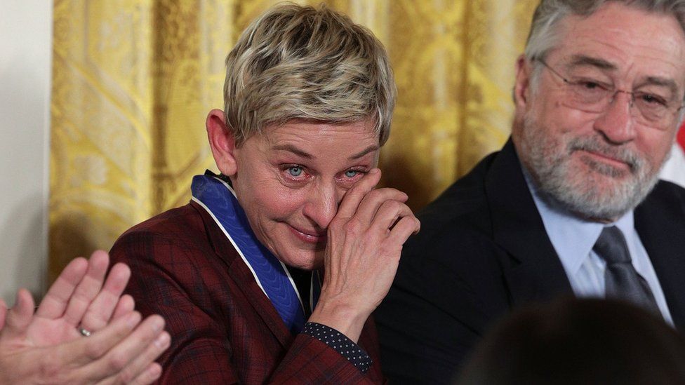 Comedian and talk show host Ellen DeGeneres wipes tears as actor Robert De Niro looks on