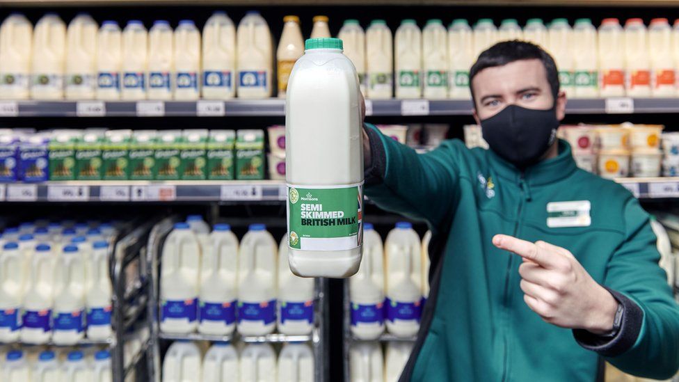 Store worker holding milk