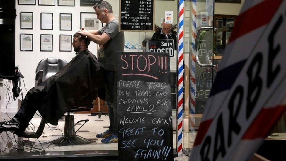 A barber cuts a customer's hair in Christchurch, on 14 May, 2020.