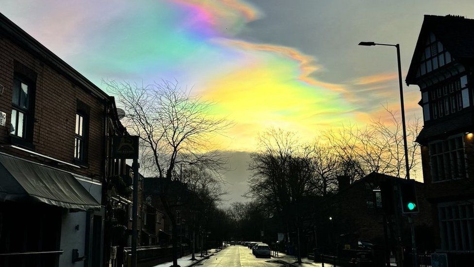 Rainbow cloud hangs over road in West Didsbury