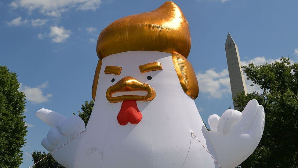 An inflatable chicken mimicking US President Donald Trump appears near the White House in Washington DC, 9 August 2017