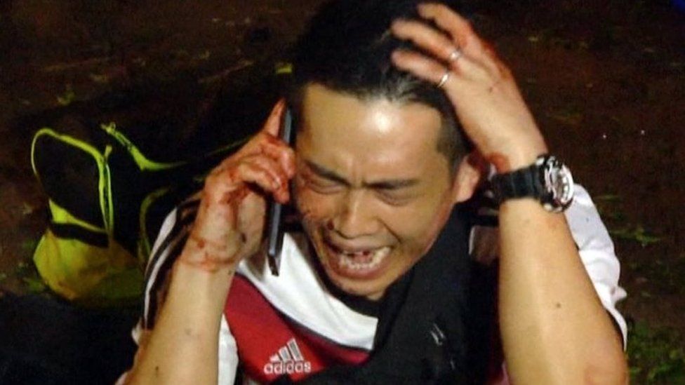 Man cries on the phone at scene of blast in Bangkok