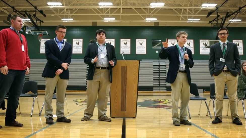 Tyler Ruzich (2ndR), 17, flanked by Ethan Randleas (L), 17, and Jack Bergeson (3rdL), 16, and his running mate Lt Governor Candidate Alexander Cline (2ndL) and Dominic Scavuzzo, 17, (R), speaks during a forum.
