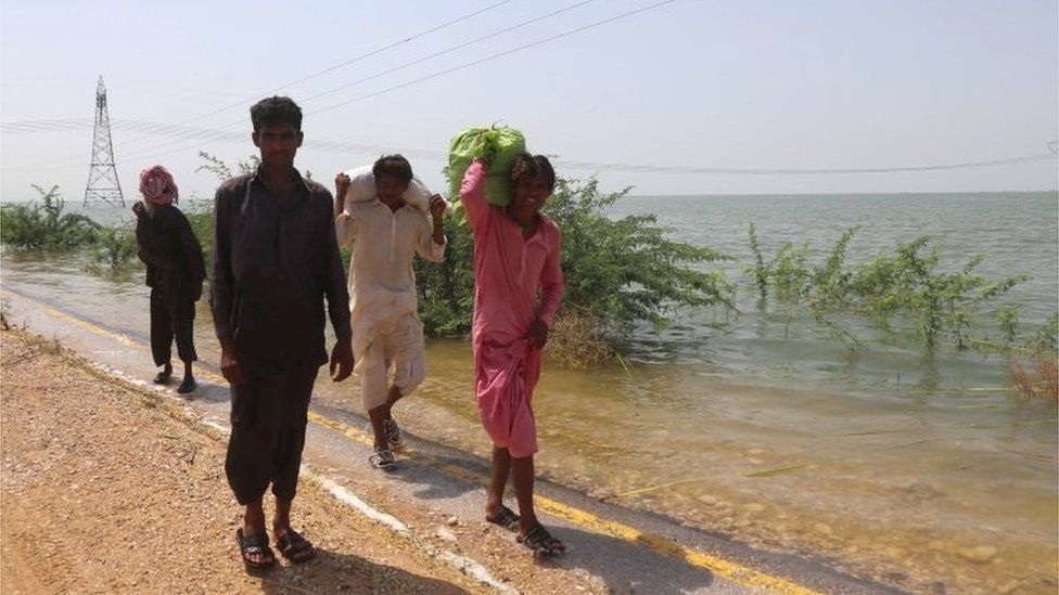 People move to higher grounds after their villages were inundated by flood following a breach in Manchar Lake to reduce overflow, in Jamshoro district, Sindh province, Pakistan, 06 September 2022.