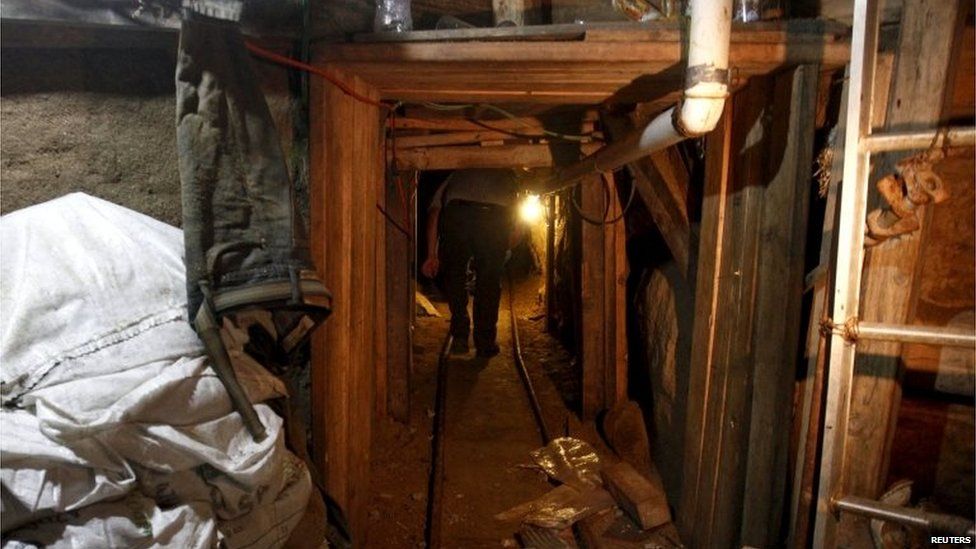 A journalist walks through a tunnel discovered by the Mexican authorities during a presentation to the media in Tijuana on 2 August, 2015.