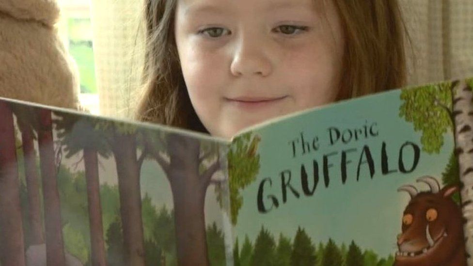 Girl reading The Doric Gruffalo