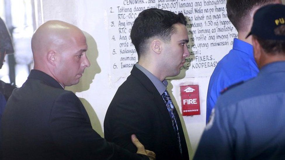 U.S. Marine Lance Corporal Joseph Scott Pemberton (C) is escorted by U.S. security officers into a court in Olongapo city, north of Manila December 1, 2015.