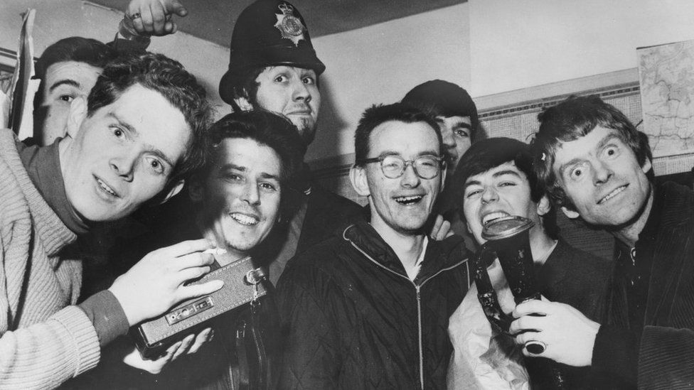 20th January 1966: The disc jockeys of seagoing pirate radio station, Radio Caroline at Walton police station in Essex after their ship ran aground in bad weather. The DJ's, including Dave Lee Travis (in hat) and Tony Blackburn
