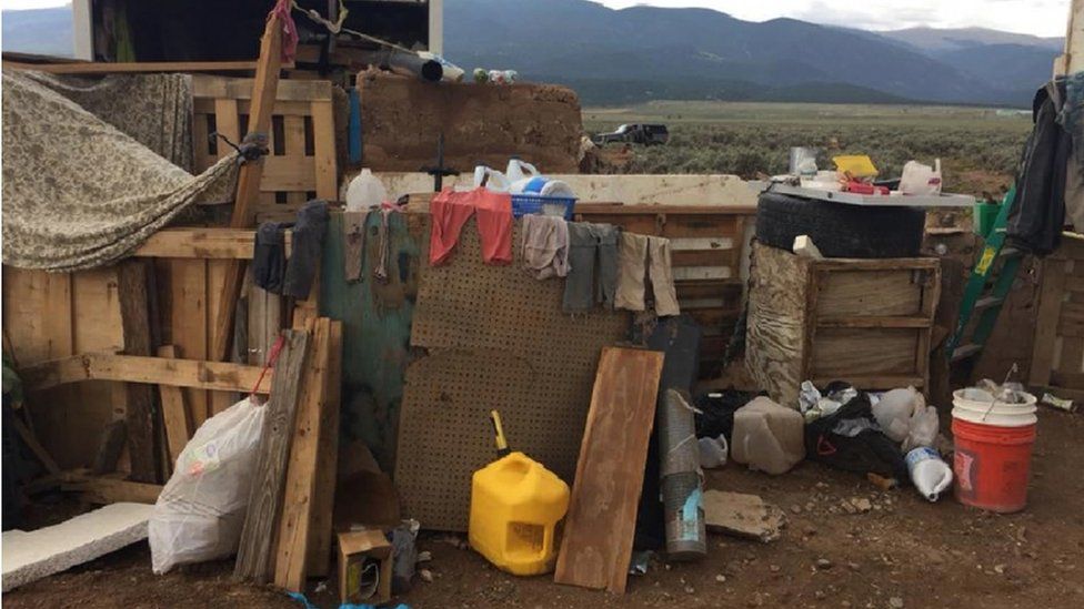 Dirty clothing and makeshift structures at the compound