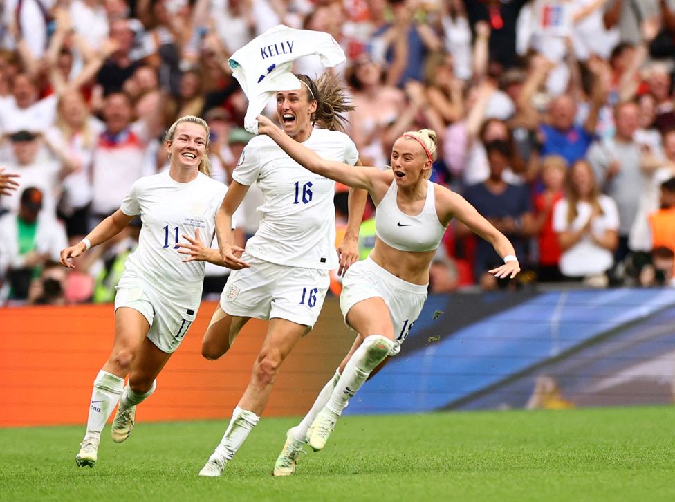 England's Chloe Kelly celebrates scoring their second goal with Jill Scott and Lauren Hemp at Wembley Stadium, London, 28 July 2022.