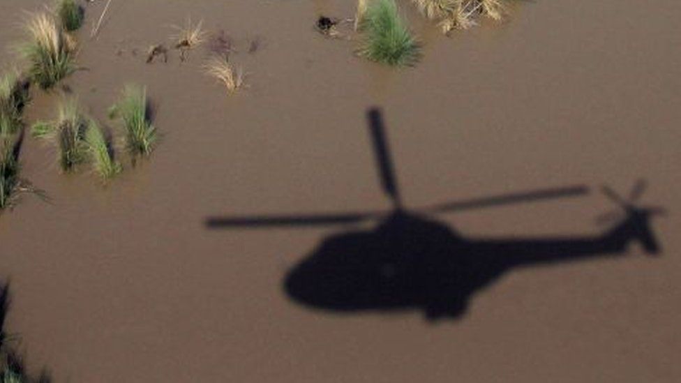A helicopter hovering over the floods in Pakistan