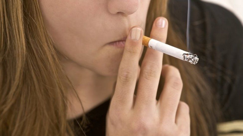 A woman smokes a cigarette. File photo