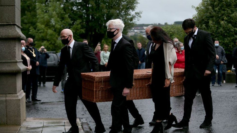 The coffin of John Hume is brought into St Eugene's Cathedral in Londonderry
