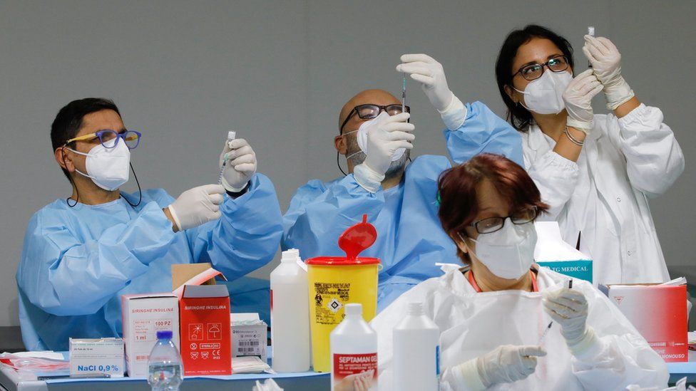 Health workers prepare doses of the Pfizer-BioNTech COVID-19 vaccine at a coronavirus disease (COVID-19) vaccination centre in Naples, Italy, January 8, 2021.
