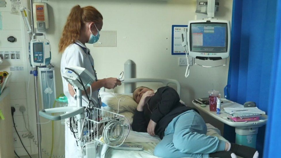 Claudia Laird on hospital ward attending to patient