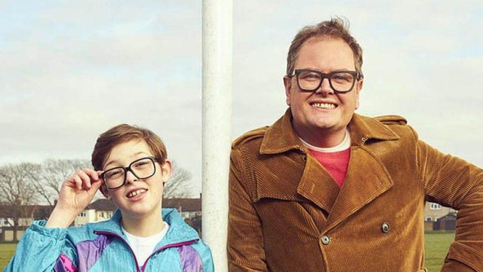 Oliver Savell and Alan Carr pose on a football pitch in a promotional image for Changing Ends
