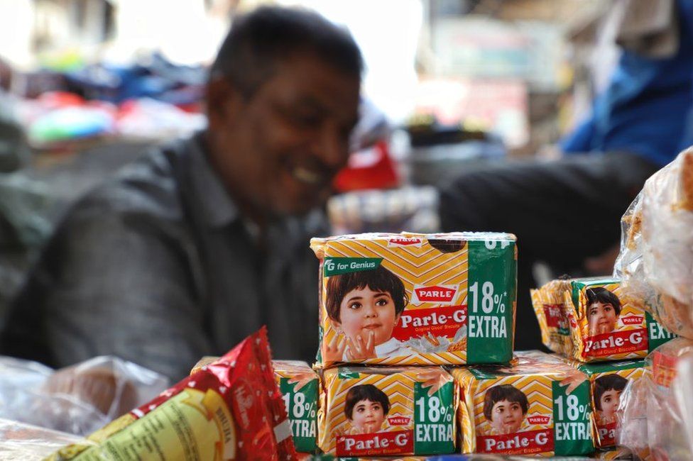 A vendor sells Parle Parle-G biscuits outside a metro station in New Delhi on 08 September 2019.