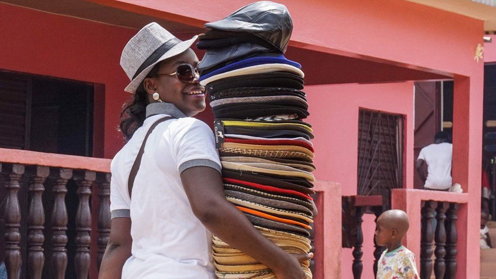 A vendor sells hats and caps in Yamoussoukro on June 11, 2017. / AFP PHOTO / ISSOUF SANOGOISSOUF SANOGO/AFP/Getty Images