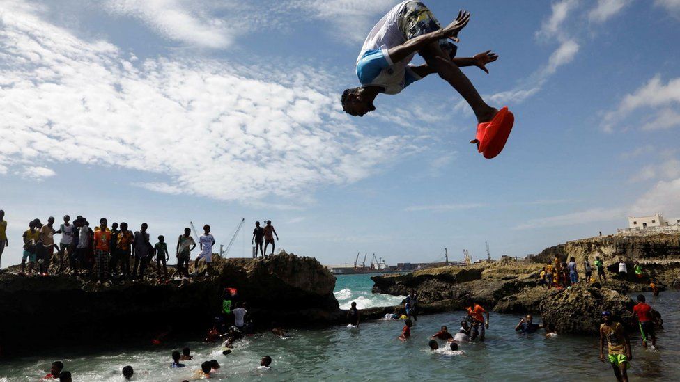 A man jumps as he plays at the Hamarweyne Beach in Mogadishu, Somalia - Friday 29 December 2023