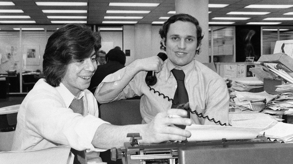 Bernstein and Woodward sitting in newsroom