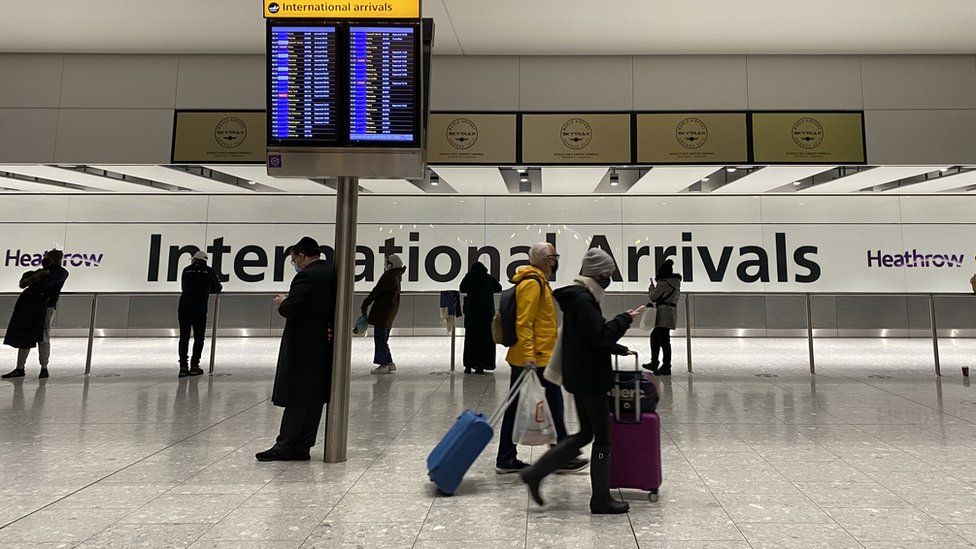 People in arrivals at Heathrow Airport