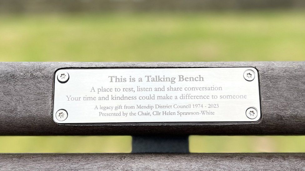 a plaque on a park bench saying it's a talking bench