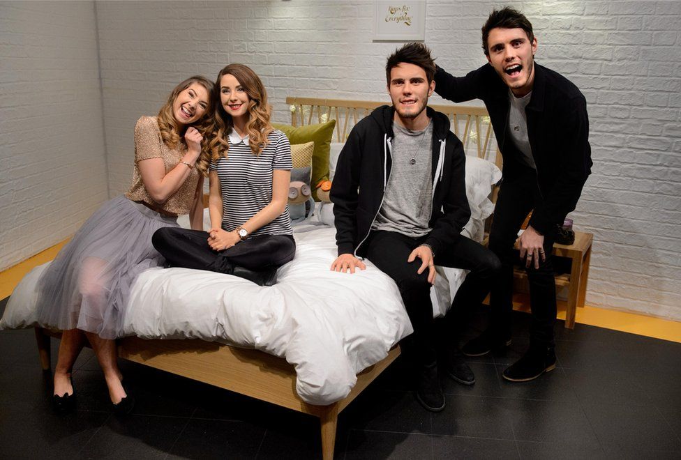 Zoe Sugg and Alfie Deyes with their wax figures at Madame Tussauds