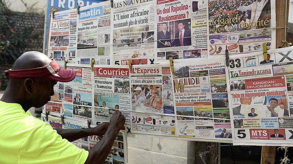 A newsstand vendor displays newspapers in Antananarivo