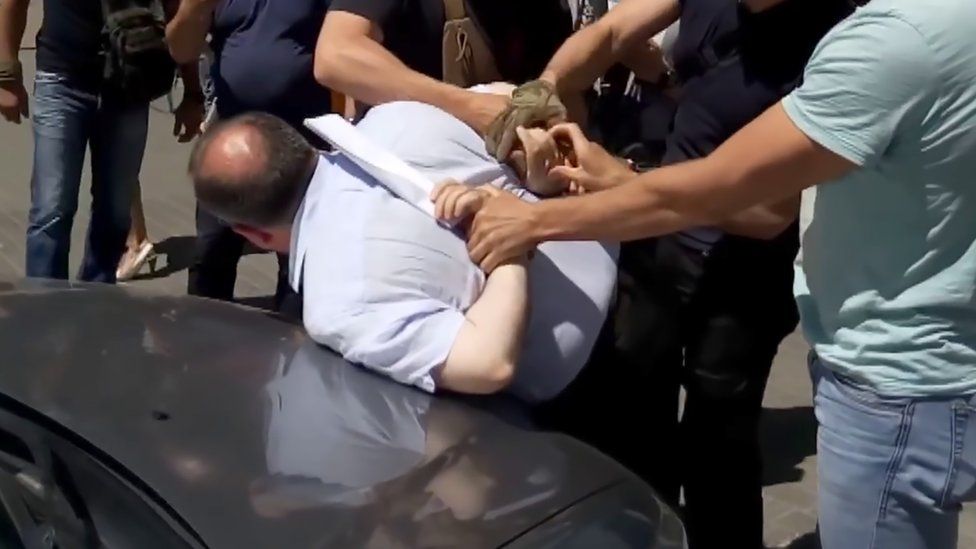 In this video grab made on May 30, 2018 from a YouTube video posted by Ukraine"s security service (SBU), officers arrest the alleged mastermind of an alleged Russian plot designed to kill prominent Russian anti-Kremlin journalist