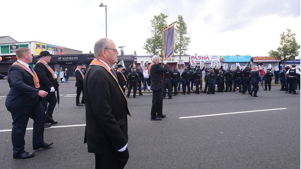 Police in riot gear escorted an Orange Order feeder parade past nationalist protests in Ardoyne on Tuesday morning