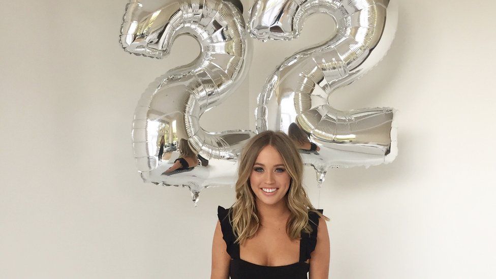 Lauren Trent with balloons saying 22