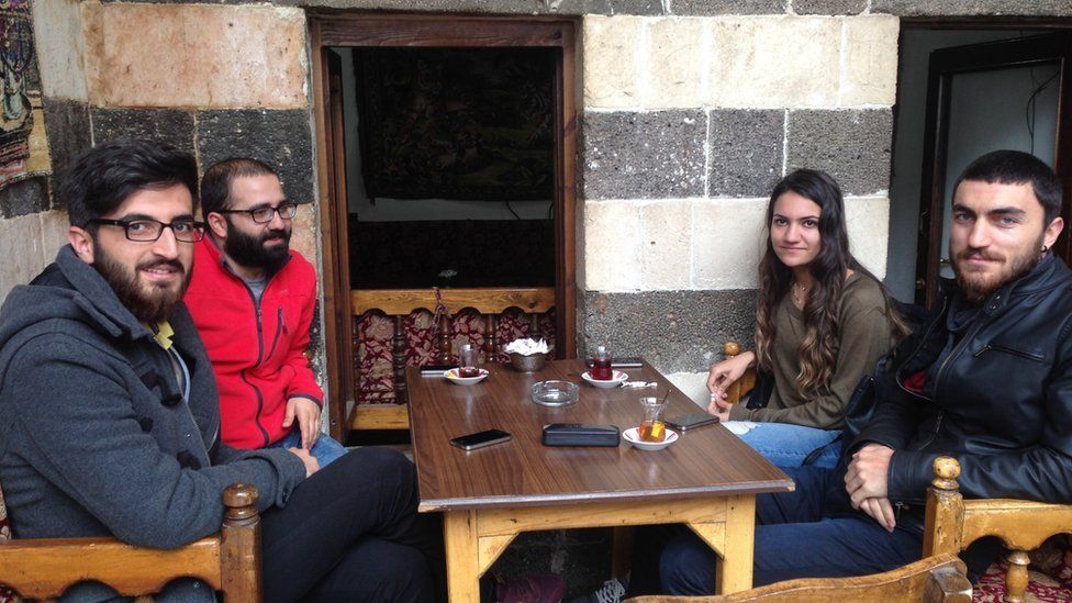 Four young residents of Diyarbakir drink tea in the city's Hasanpasa Hani market.