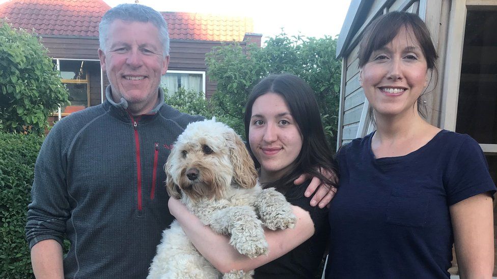 Parents with daughter and dog